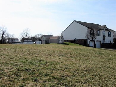 Side view of the 2 storage sheds and empty lot bes