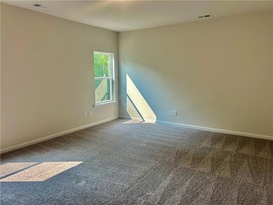 Empty room with carpet and baseboards