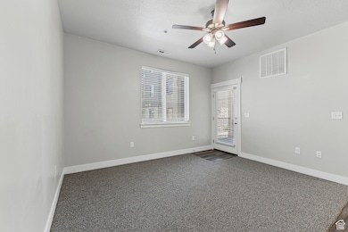 LIving room with carpet flooring, a textured ceiling, and ceiling fan