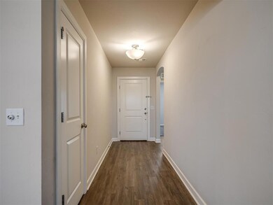 Hallway featuring dark faux wood-style floors