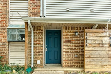 View of exterior entry featuring brick siding