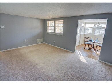Family room with view to dining room. Natural ligh