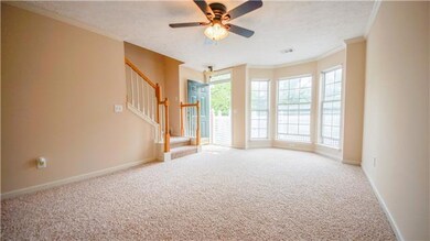 Enjoy natural lighting, new plush carpet, fireplace, stylish ceiling fan, and...