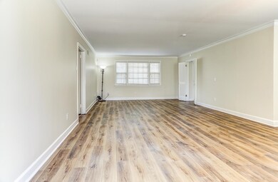 Unfurnished room featuring ornamental molding and wood finished floors