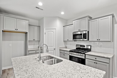 Kitchen with light hardwood / wood-style floors, s