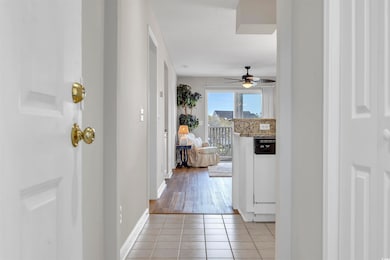 Hall featuring light tile patterned flooring