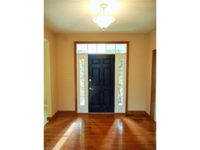 The wood floored foyer is flanked by a dining room