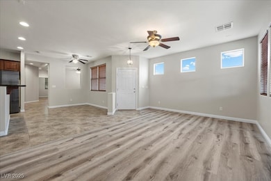 Unfurnished living room with ceiling fan, recessed