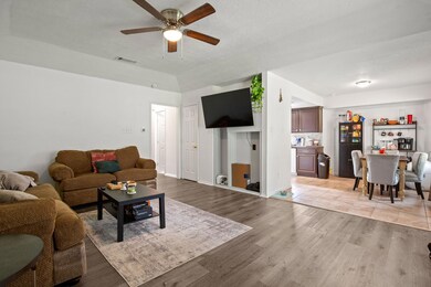 Living room featuring a ceiling fan and light woo