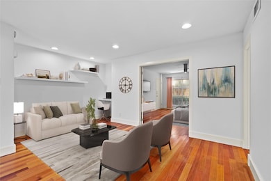 Living room with wood finished floors, baseboards,