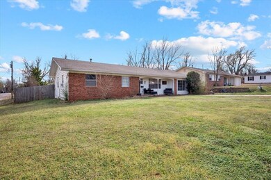 Single story home featuring brick siding, a front 
