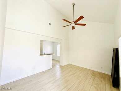Unfurnished living room with high vaulted ceiling,