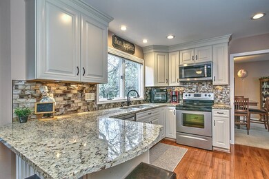 Updated Kitchen, Cabinets, Glass Back Splash, Granite Counter Tops, SS Appliances, & Wood Flooring.