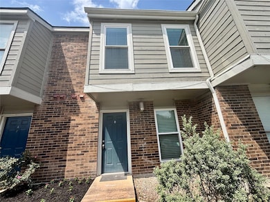 Property entrance featuring brick siding