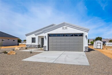 Ranch-style house featuring a garage, stucco sidin