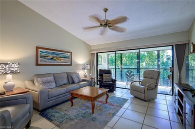 Tiled living room featuring vaulted ceiling, ceili