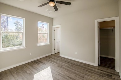 Unfurnished bedroom featuring a walk in closet, v