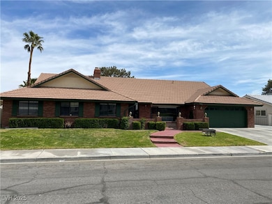 Ranch-style home with a garage, a tiled roof, a ch
