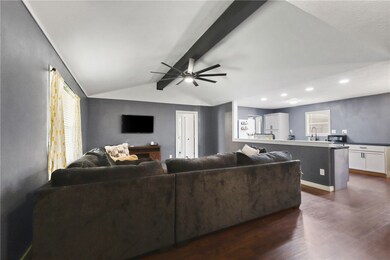 Living area with dark wood finished floors, ceilin