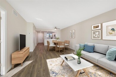 Living room featuring wood plank look/ tile floors, baseboards, and a ceiling fan