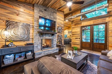Living room featuring a fireplace, wooden ceiling,