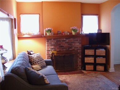 Living room with wood burning fireplace.
