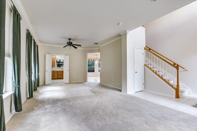 Unfurnished living room with crown molding, a cei