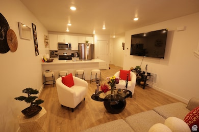 Living room featuring light wood-style floors and recessed lighting