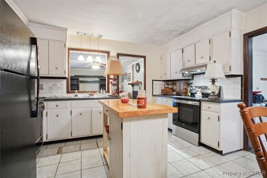 Kitchen featuring a center island, tasteful backsp