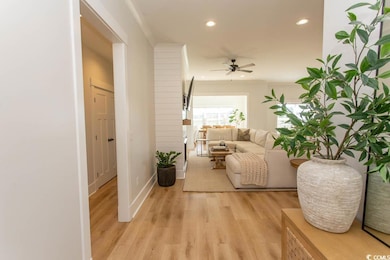 Hall featuring light wood-style flooring and recessed lighting