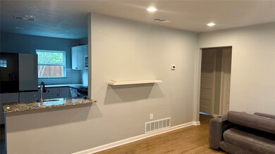 Living area with dark wood-style floors and recessed lighting
