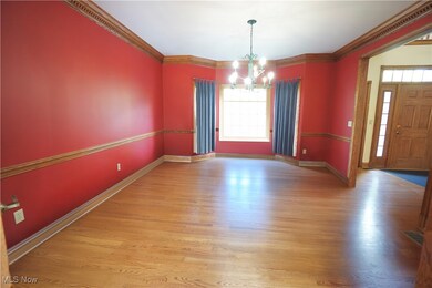 Unfurnished dining area featuring ornamental molding, light wood-style floors, and a chandelier