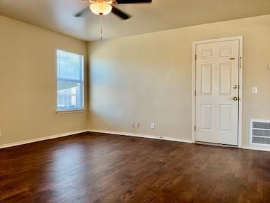 Spare room with dark wood-type flooring and a cei