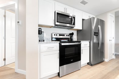 Kitchen with visible vents, light wood finished f
