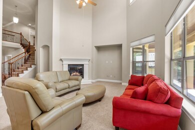 Living room with a towering ceiling, carpet floor