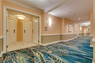 Corridor featuring tile patterned floors, baseboar