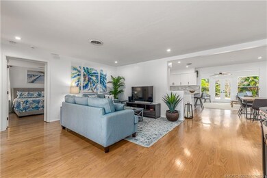 Living area with main bedroom to left and dining/k