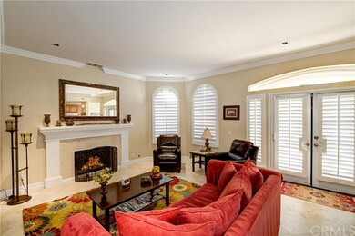 Open family room with a romantic fireplace and Pla