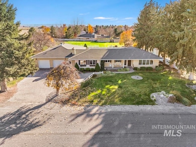 View of front of home featuring a front lawn, driveway, an attached garage, and a chimney