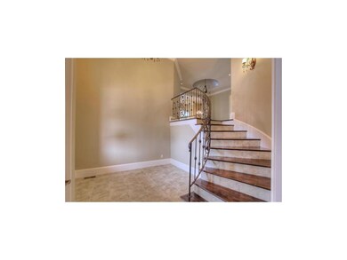 Dramatic soaring entry with gleaming floors and wi