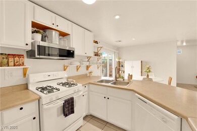 Kitchen with white cabinetry, open shelves, white