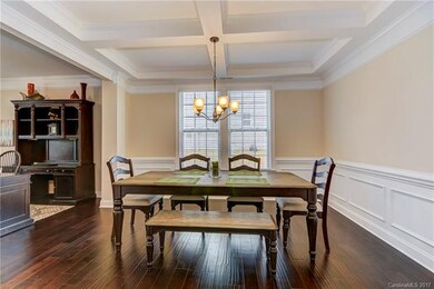 Formal dining room with coffered ceiling and wains