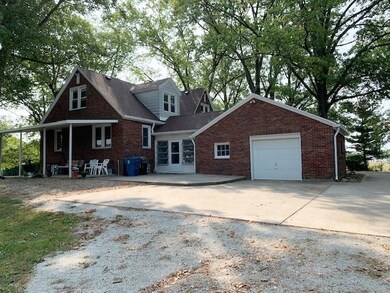 Rear elevation w/large concrete driveway.