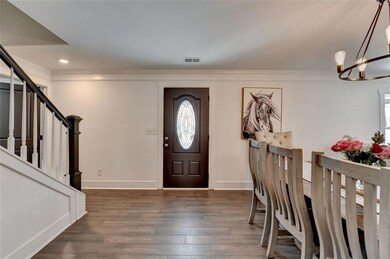 Foyer entrance featuring visible vents, baseboards
