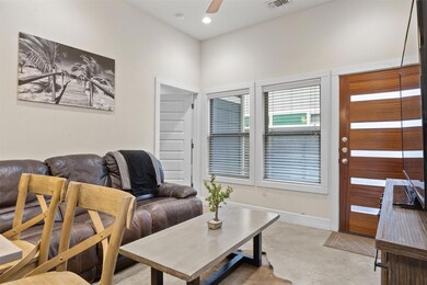 Living room featuring a ceiling fan, light colore