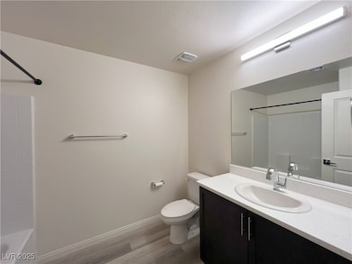 Full bathroom featuring wood finished floors, vani