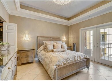 Bedroom with french doors, a tray ceiling, access 