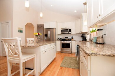 Stainless steel appliances and vaulted ceilings wi