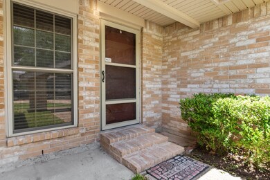 A view of the front door which is enclosed by a nice overhang.