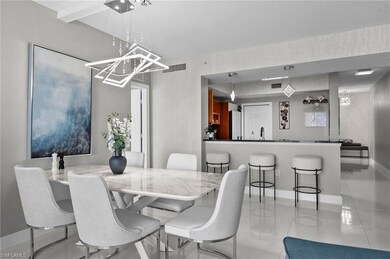 Tiled dining room featuring sink and a chandelier